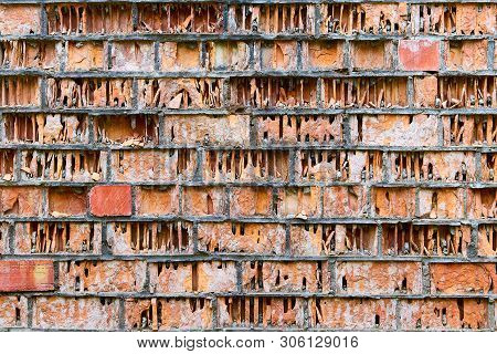 Old Crumbling Ruined Wall Of Red Damaged Bricks Like A Book In A Library