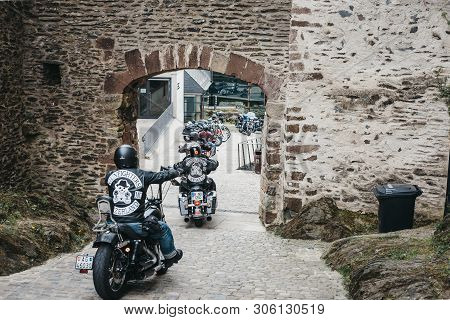 Vianden, Luxembourg - May 18, 2019: Gunfighters Bikers Riding Through A Gate Inside Vianden Castle, 