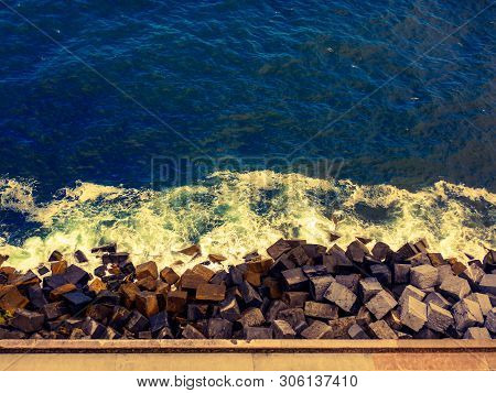Vibrant Ocean Surface With Abstract Color Where The Sea Meets The Rock And Rock Meets The Footpath F