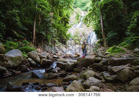 Asian Women Relax In The Holiday. Travel Waterfall On The Moutain (huai Toh Waterfall) At Krabi. Tra