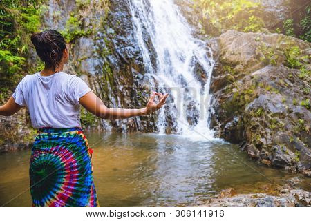 Asian Women Relax In The Holiday. Play If Yoga.  Play If Yoga At Waterfall On The Moutain. Exercise,