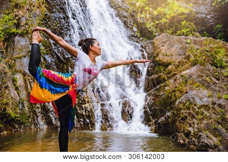 Asian Women Relax In The Holiday. Play If Yoga.  Play If Yoga At Waterfall On The Moutain. Exercise,