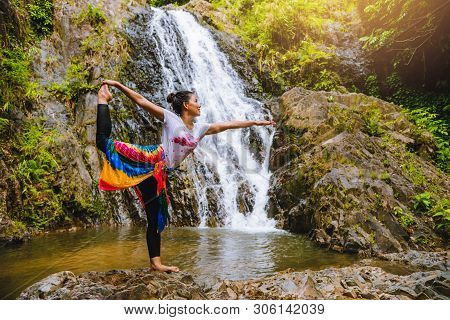 Asian Women Relax In The Holiday. Play If Yoga.  Play If Yoga At Waterfall On The Moutain. Exercise,