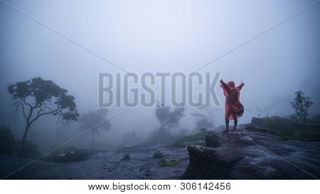 Tourist With Rain Coat Walking Travel Adventure Nature In The Rain Forest At Phu Hin Rong Kla Nation