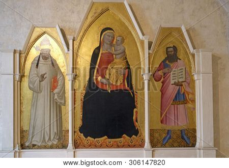 FLORENCE, ITALY - JANUARY 10, 2019: Madonna and Child with St. Gregory and St. Job, Triptych by Nardo di Cione, Basilica di Santa Croce - famous Franciscan church in Florence, Italy