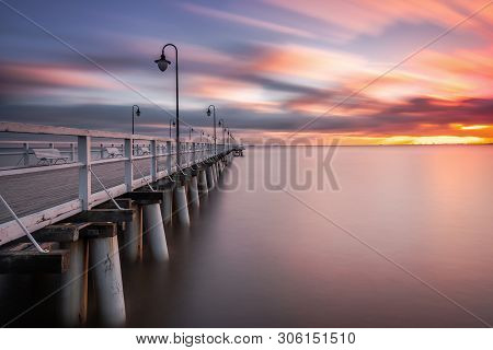 Wooden Pier In Gdynia Orlowo In The Morning With Colors Of Sunrise. Poland. Europe.
