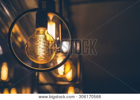 Vintage Tungsten Filament Multiple Lamps Of Different Size Hanging From The Ceiling. Interior Design