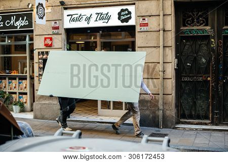 Barcelona, Spain - Nov 14, 2017: Construction Workers Transporting Holding A Rigips Plaster Board On