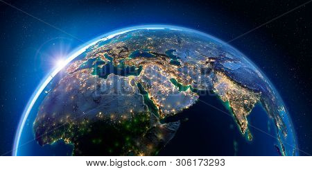 Planet Earth At Night With The Rising Sun With The Light Of Cities Illuminating A Detailed Exaggerat