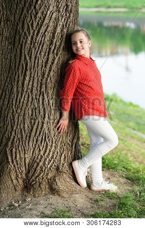 Feeling Free And Happy. Adorable Baby Girl. Small Baby With Cute Smile On Natural Landscape. Little 