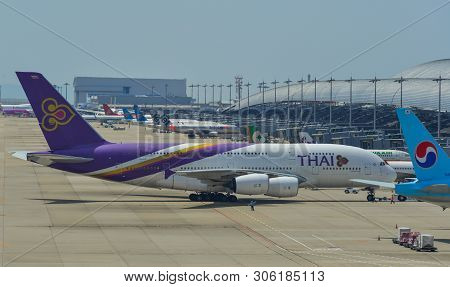 Passenger Airplanes Taxiing On Runway