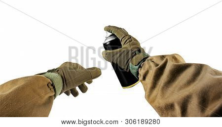 First person view military hands in tactical jacket and gloves holding paint spray can.