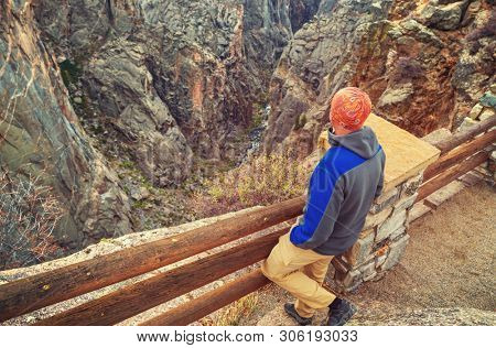 Tourist on the granite cliffs of the Black Canyon of the Gunnison, Colorado, USA