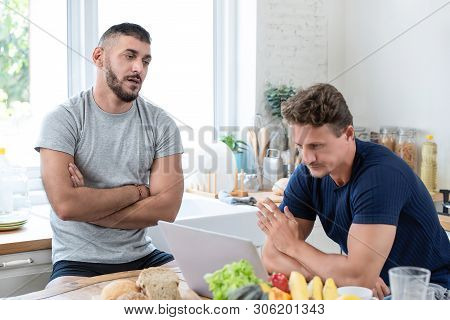 Mature Caucasian Gay Male Couple Having An Arguement While Having Breakfast In The Morning At Home