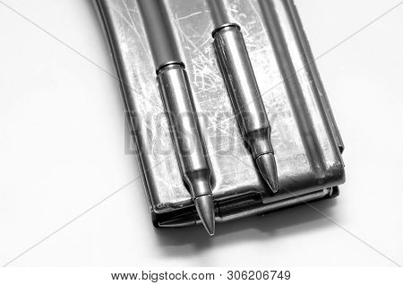 223 Caliber Bullets Loaded Into A Rifle Magazine With Two Additional Bullets Shot In Black And White