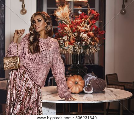 Fancy Young Girl Shooting For The New Autumn Collection. Wearing Oversize Pink Sweater, Long Skirt W