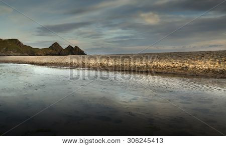 The Stream Or River That Disects Three Cliffs Bay On The Gower Peninsula, Swansea, Wales, Uk