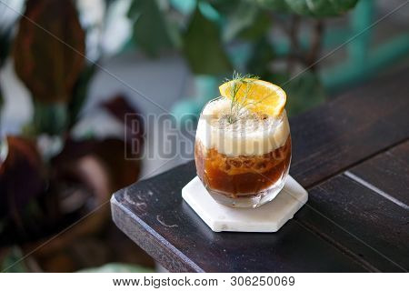 Iced Coffee Shakerato - A Glass Of Espresso Shot Mixed With Craft Soda And Orange Juice And Topped W