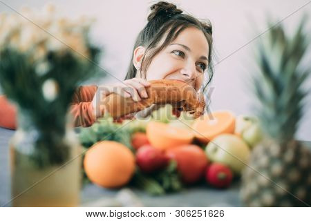 Young Woman On A Diet Succumbed To Temptation And Passionately Bites A White Crispy Long Loaf. The C