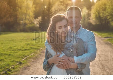 A Young Couple Spends Time Together Outdoors. Couple Having Fun Summer Time.