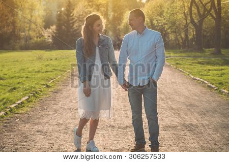 A Young Couple Spends Time Together Outdoors. Couple Having Fun Summer Time.