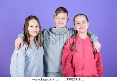 Children Smiling Faces On Violet Background. Friends Hug. Childrens Day. Cheerful Youth. Relations A