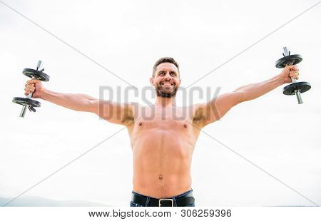Free Your Mind. Fitness And Sport Equipment. Success. Perfect Biceps. Muscular Man Exercising In Mor