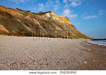 The Sandstone Cliffs Of The Jurassic Era Rising From Salcombe Regis Beach