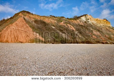 The Sandstone Cliffs Of The Jurassic Era Rising From Salcombe Regis Beach