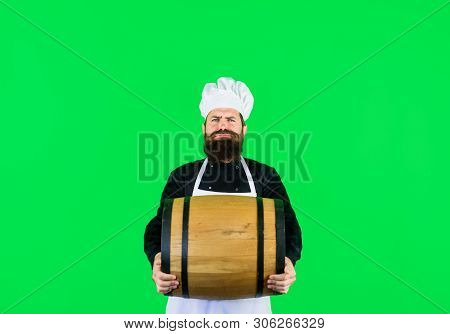 Attractive Bearded Man With Wooden Barrel Of Wine Or Beer. Chef Man Holds Wooden Wine Barrel. Handso