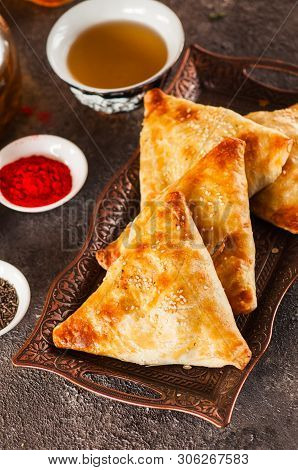 Freshly Baked Eastern Samsa On A Vintage Tray. Close Up.traditional Eastern Pastry - Samsa Filled Wi