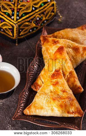 Freshly Baked Eastern Samsa On A Vintage Tray. Close Up.traditional Eastern Pastry - Samsa Filled Wi