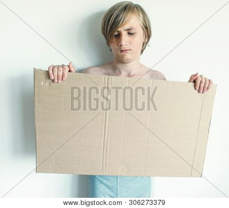 Boy Showing Blank Signboard with Empty Copyspace