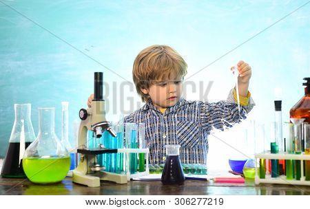 Back To School And Happy Time Kid Is Learning In Class On Background Of Blackboard. What Is Taught I