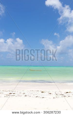 Fishing Boat On Picture Perfect White Sandy Beach With Turquoise Blue Sea, Paje, Zanzibar, Tanzania.