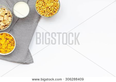 Cereals, Oatflakes And Cornflakes With Milk For Healthy Breakfast On White Background Top View Mock 