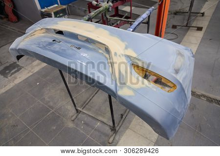 Repair Of The Rear Bumper Of A Blue Car After An Accident With The Help Of Multi-colored Putty In A 