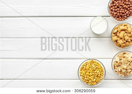 Cereals, Oatflakes And Cornflakes With Milk For Healthy Breakfast On White Wooden Background Top Vie
