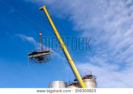 Crane Is Bringing Down Part Of Heavy Metal Construction In Industrial Complex.