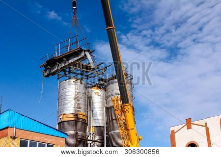Crane Is Bringing Down Part Of Heavy Metal Construction In Industrial Complex.