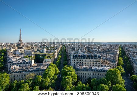 Paris Street With View On The Famous Paris Eiffel Tower On A Sunny Day With Some Sunshine