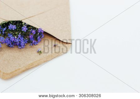 Little Cute Blue Forget-me-nots In A Kraft Paper Envelope, Selective Focus. Beautiful Bouquet Of Blu