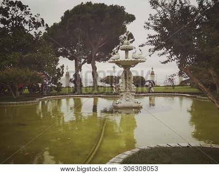 Istanbul, Turkey - September 25, 2018. Decorative Fountain Of The Dolmabahche Palace Complex On A Cl