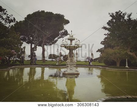 Istanbul, Turkey - September 25, 2018. Decorative Fountain Of The Dolmabahche Palace Complex On A Cl