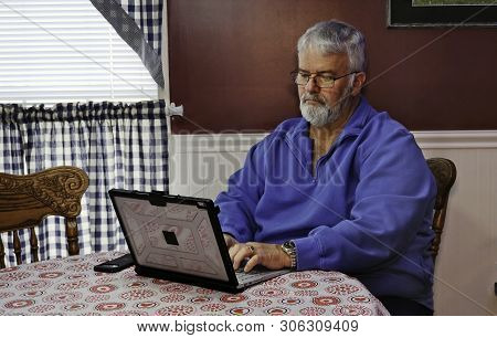 Senior Citizen Happy Using A Computer And Technology To Do Daily Activities
