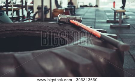 Equipment For Functional Training. Large Rubber Wheel, Hammer Closeup In The Gym. Cross Training