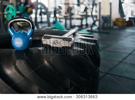 Equipment For Functional Training. Large Rubber Wheel, Hammer, Kettlebell Closeup In The Gym. Cross 