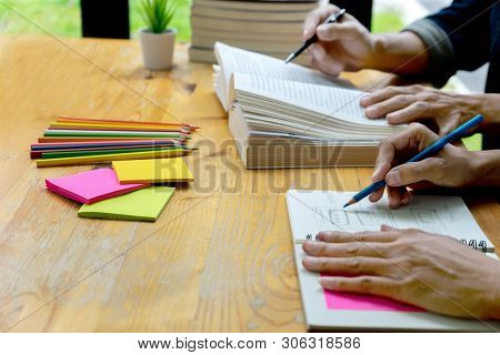 Woman And Man Work On The Table