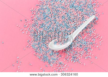 Colorful Nonpareils Cake Candy Sprinkles On Pink Background With A Spoon In Flat Lay With Copy Space