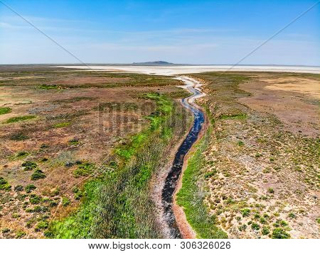 Amazing Aerial View Of Small Red Water River Leading To Baskunchak